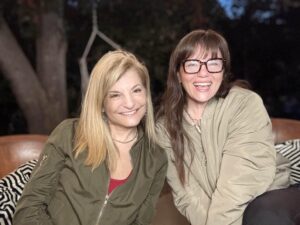 Justine Reiss and Michelle Boback sitting closely and smiling