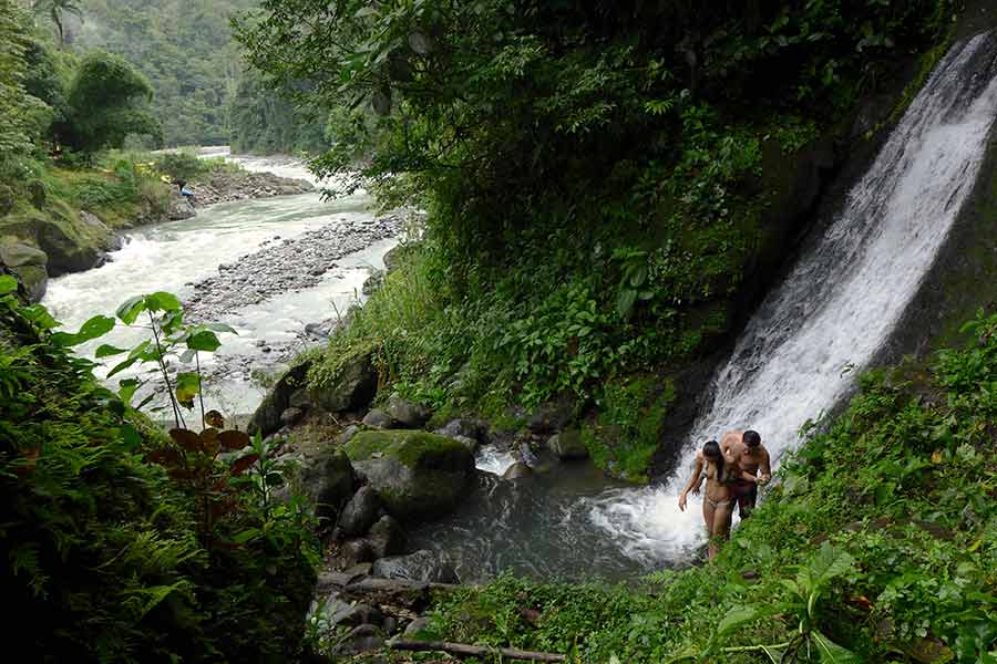 Guests at the Rios Lodge enjoy a hike to a waterfall next to the Pacuare River in Costa Rica